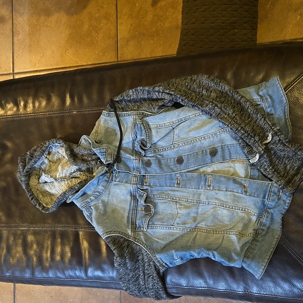 Jean jacket with sweater sleeves and hood.